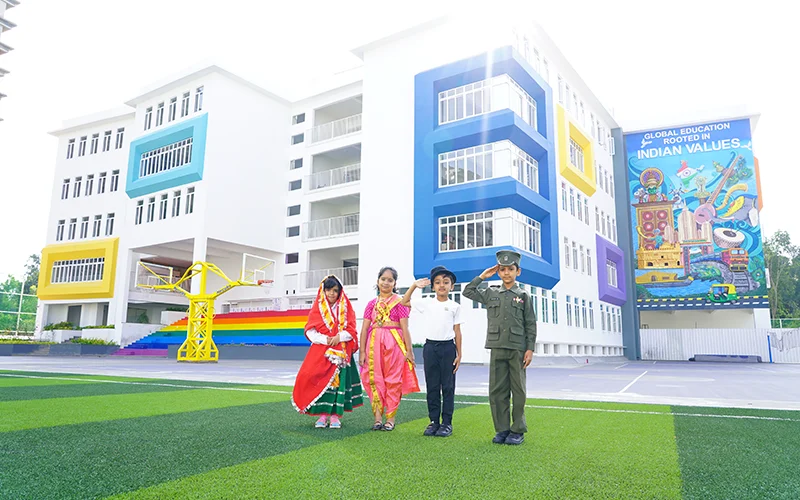 Students in cultural dress on the NHIS campus field