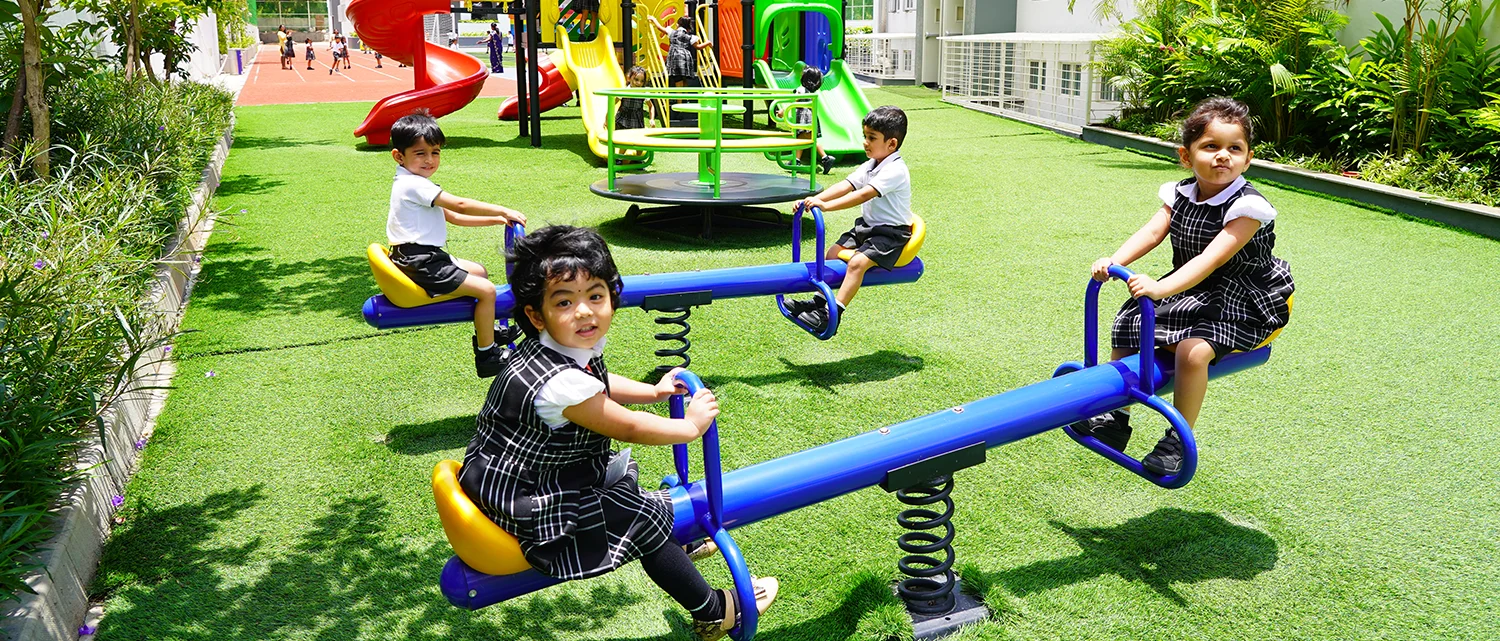 Young learners on the seesaws in the early years play area