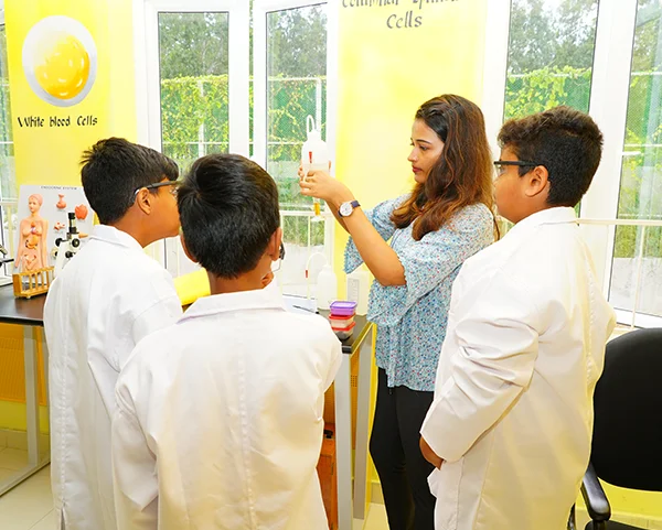 Teacher guiding students through a science experiment
