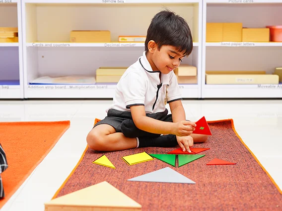 A young learner exploring Montessori materials in the classroom