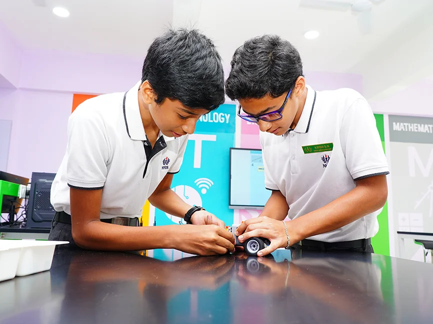Students building a robotics model in the innovation lab