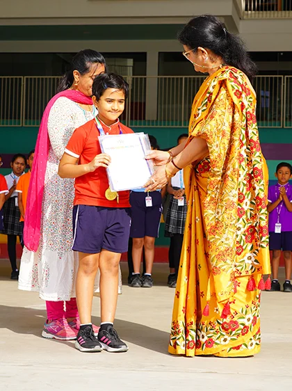 A student receiving a certificate at assembly