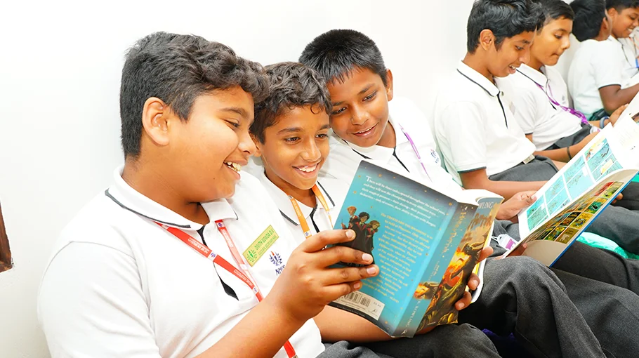 NHIS students sharing a storybook together