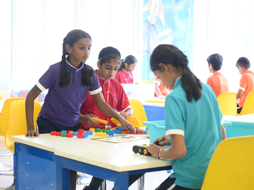 NHIS students working together on a hands-on activity in class