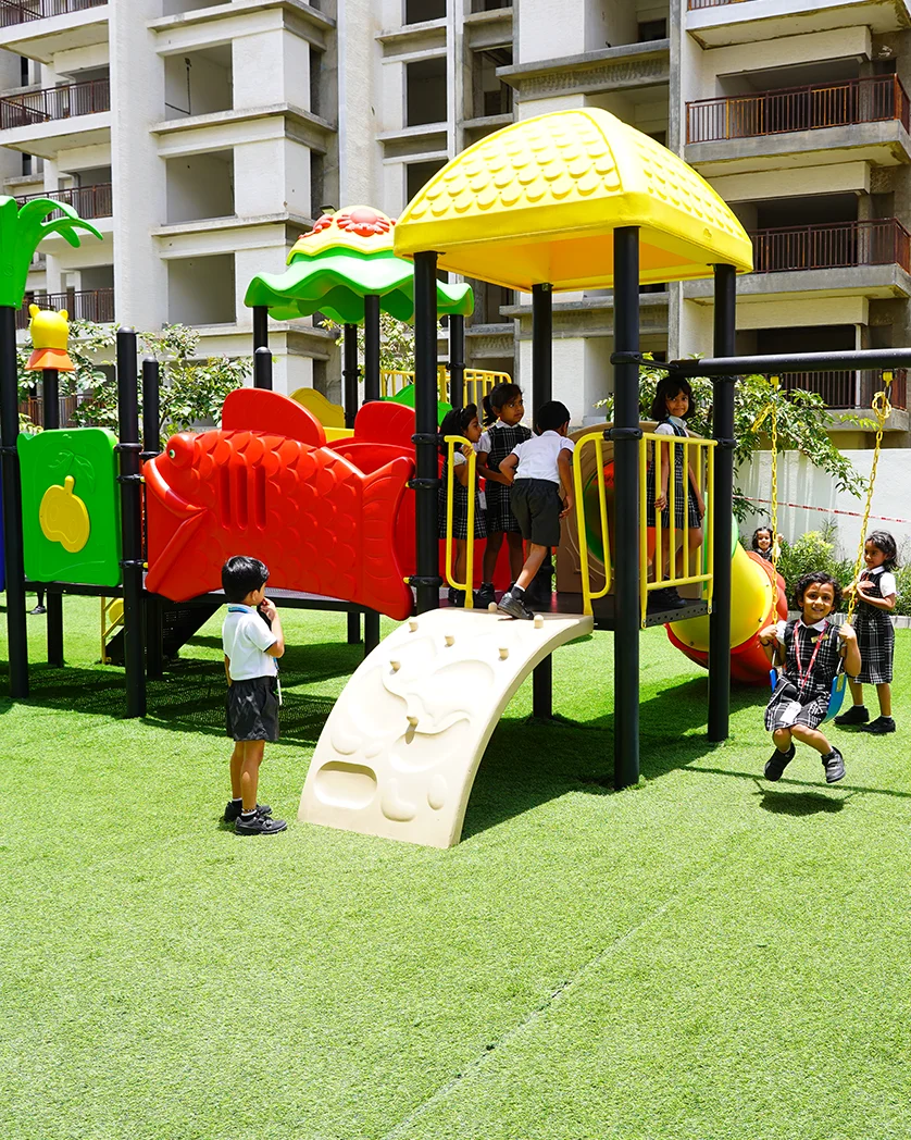 Children playing on the outdoor play structure at NHIS