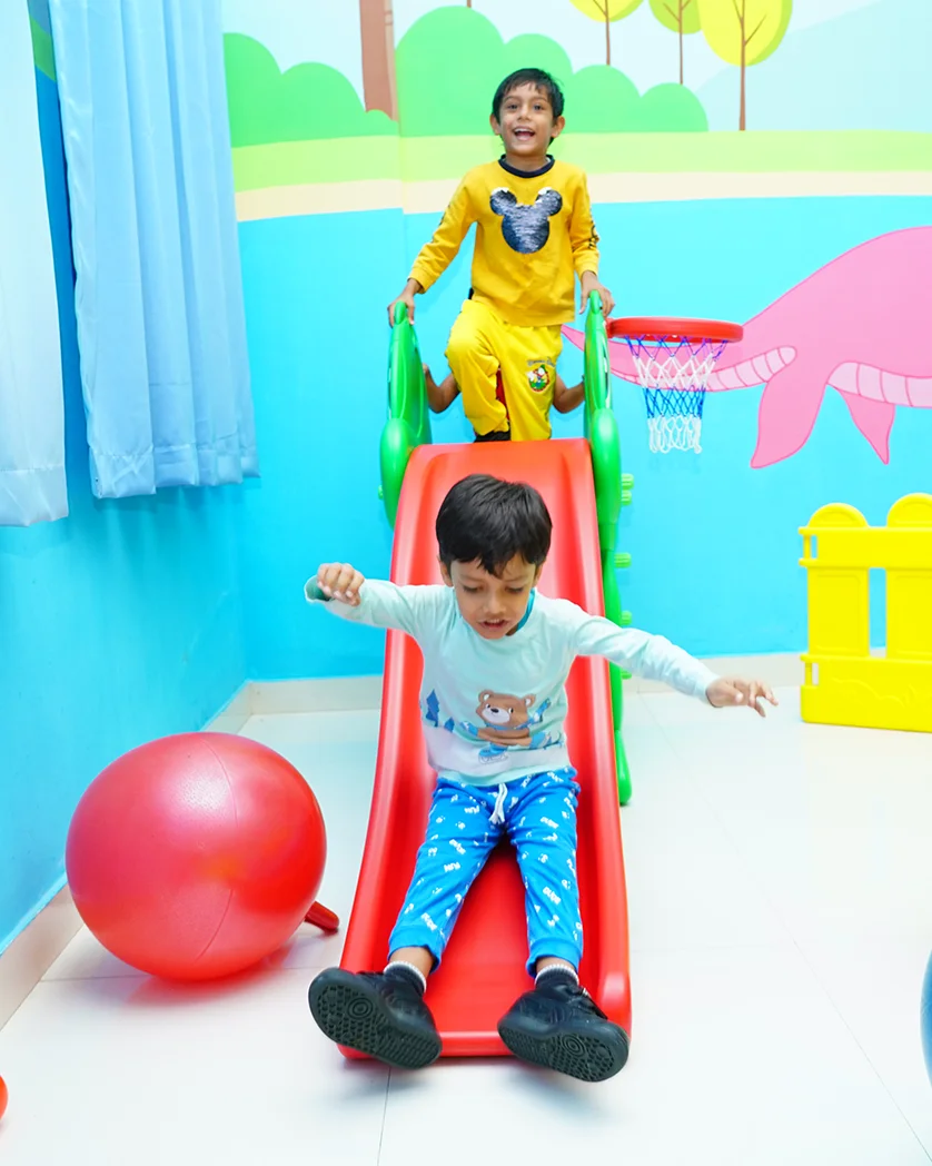 Children on the indoor slide in the NHIS activity room