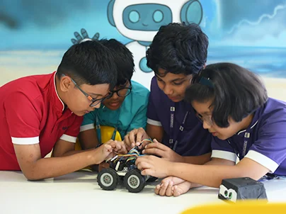 Lower secondary students working together on a group project at NHIS