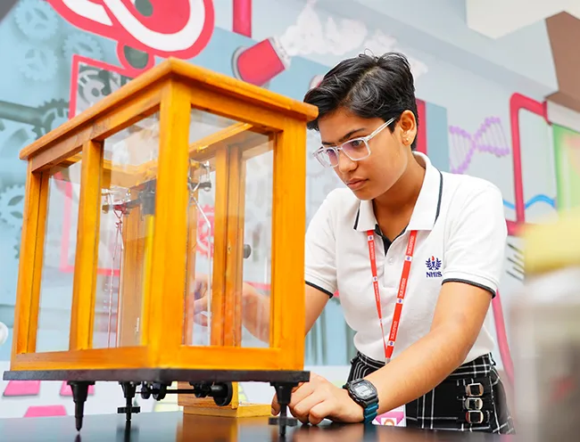 A senior student testing a physics working model